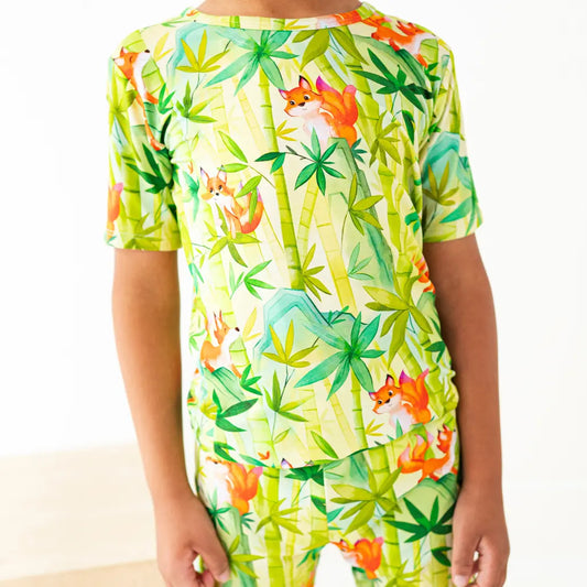 Colorful pajama set with fox and plant pattern on a white background