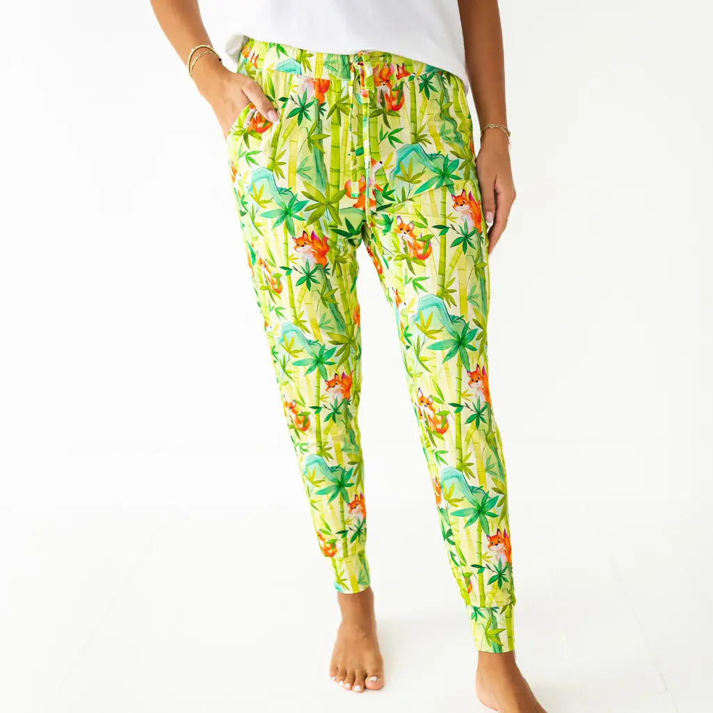 Tropical patterned pants worn by a person on a white background
