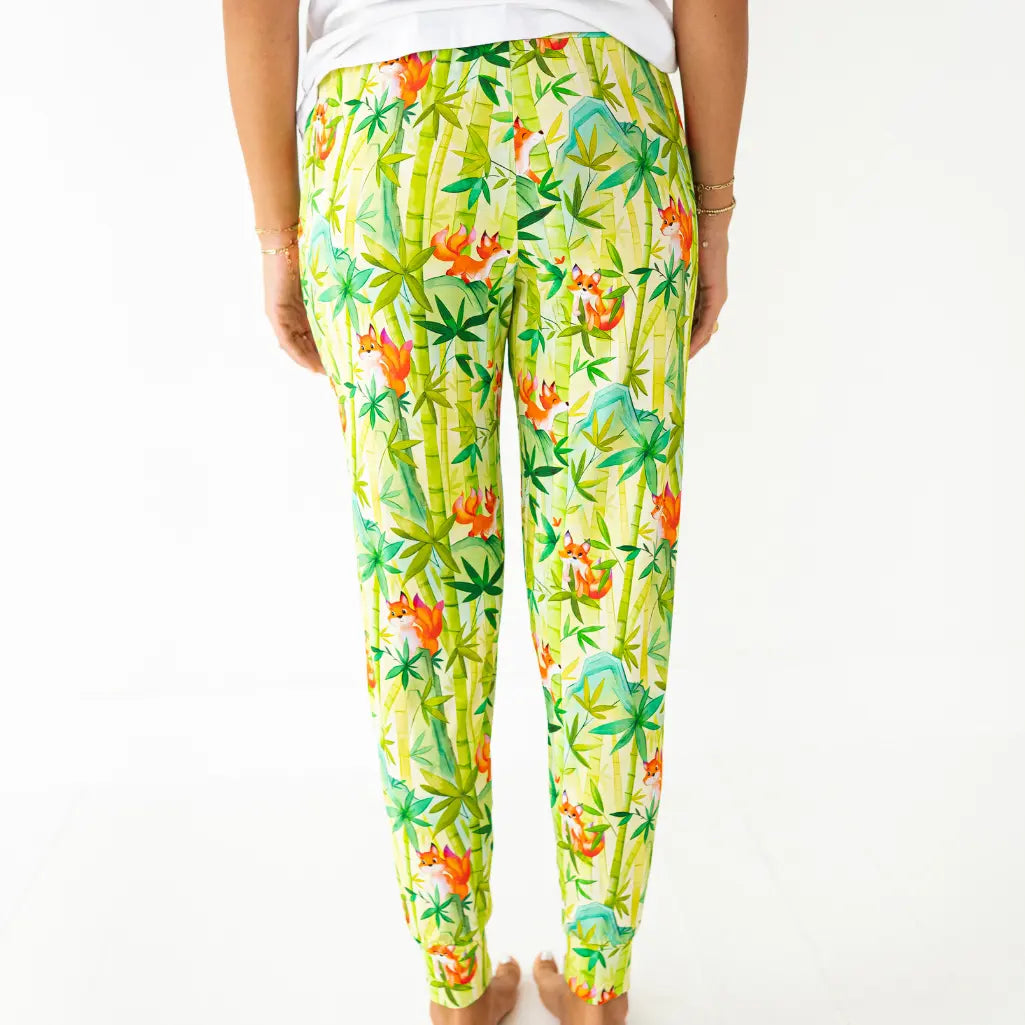 Tropical patterned pants worn by a person on a white background