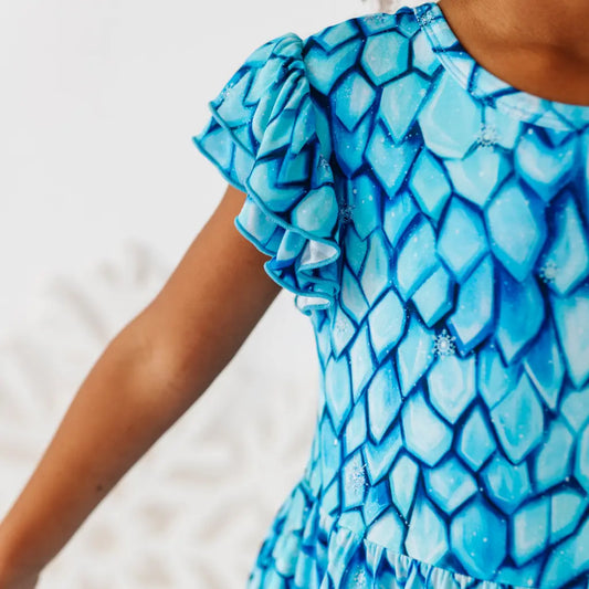 Blue patterned dress with ruffled sleeves on a blurred background