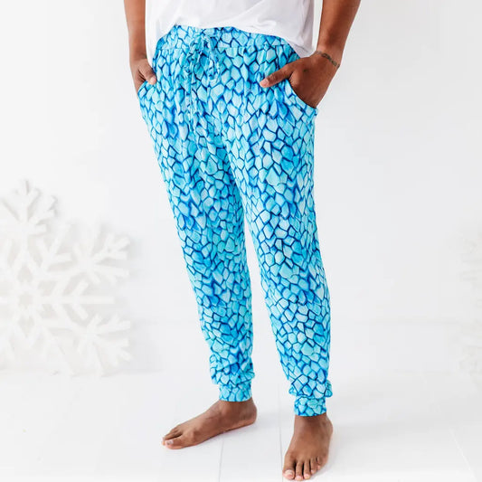 Blue patterned pants worn by a person on a white background