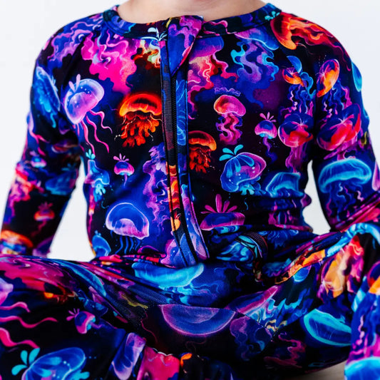 Colorful hoodie with jellyfish pattern on a plain background