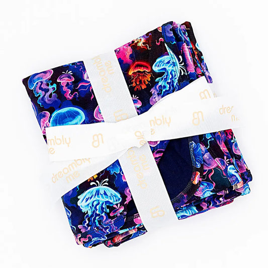 Set of colorful jellyfish-patterned products with a white ribbon on a white background