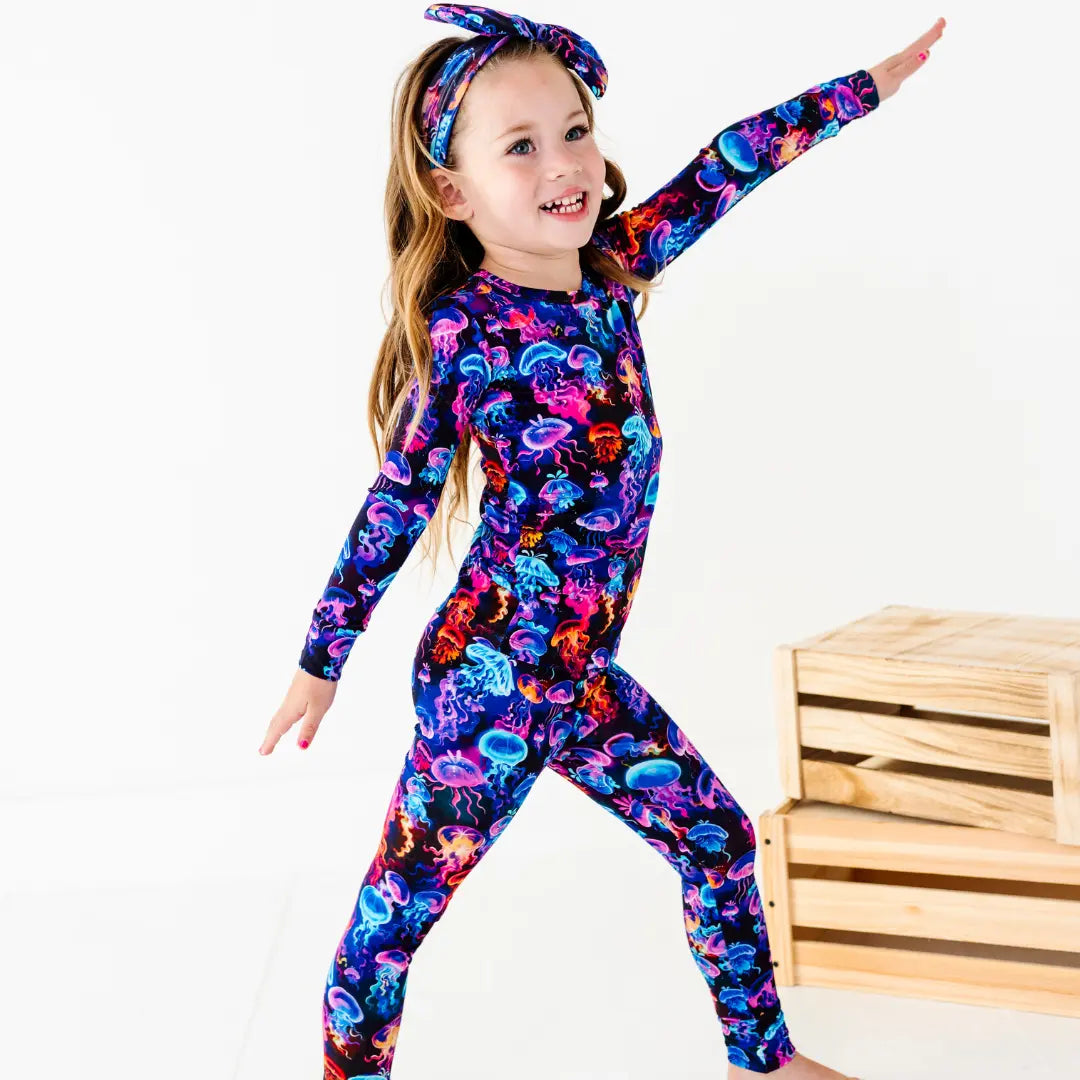 Child wearing a colorful jellyfish-themed outfit on a white background