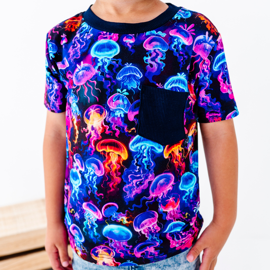 Child wearing a colorful jellyfish pattern t-shirt on a white background