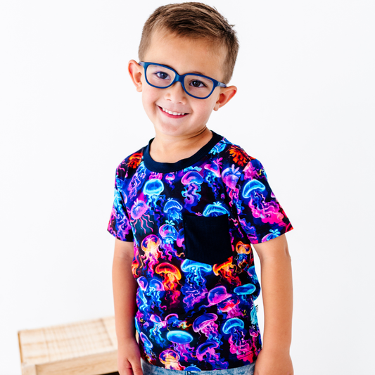 Child wearing a colorful jellyfish pattern shirt on a white background