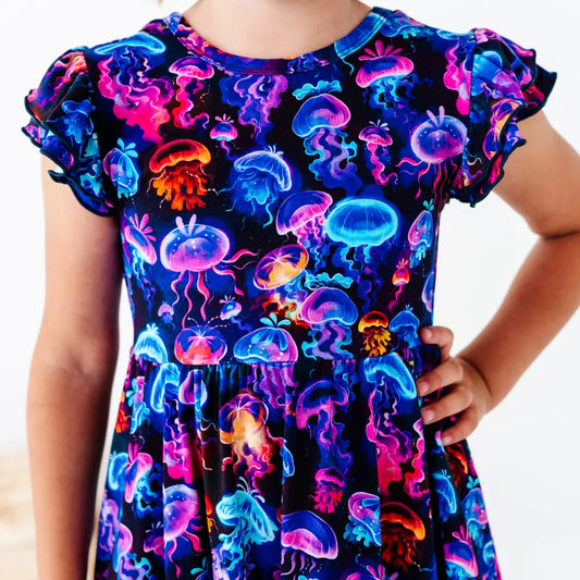Dress with colorful jellyfish pattern on a plain background