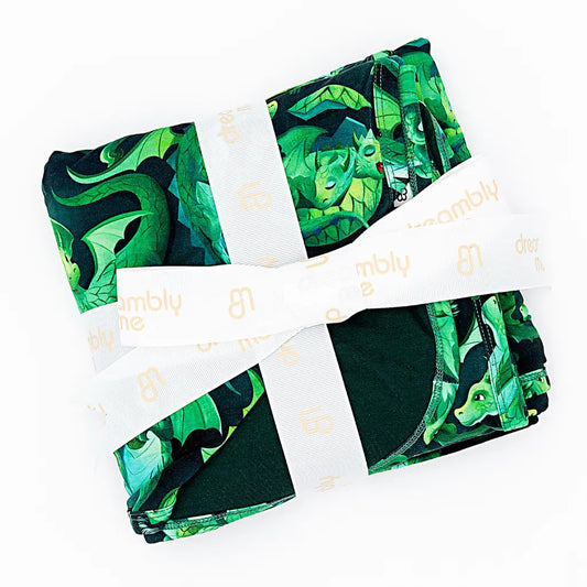 Green leaf-patterned fabric with white ribbons on a white background