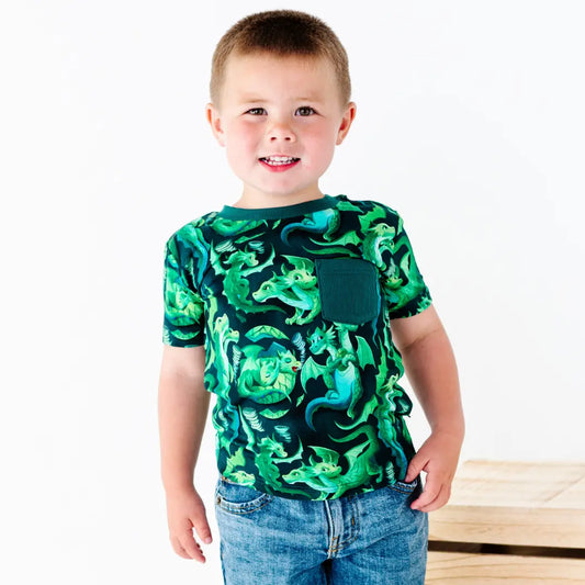 Child wearing a green dragon-patterned shirt on a white background