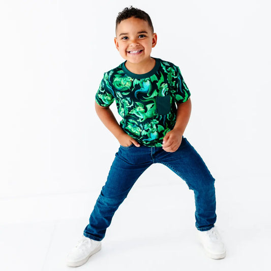 Child wearing a green camouflage shirt and blue jeans on a white background