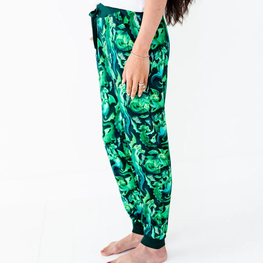 Green patterned pants worn by a person on a white background