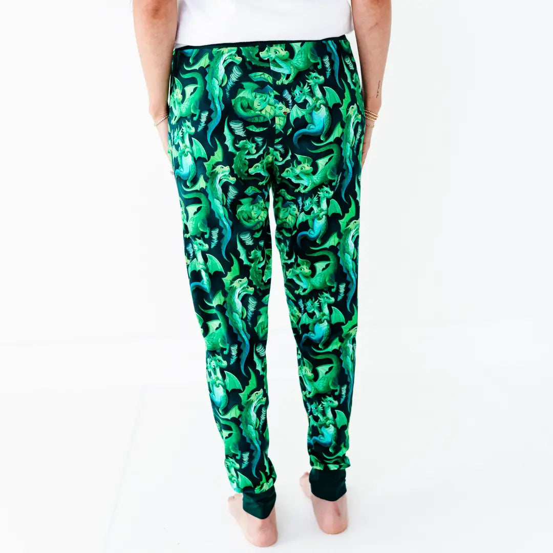 Green and black patterned pants worn by a person on a white background