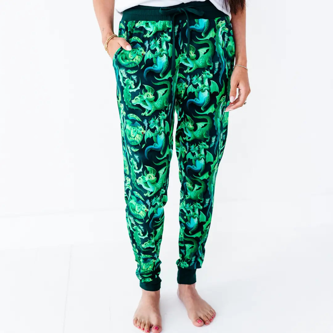 Green camouflage jogger pants worn by a person on a white background