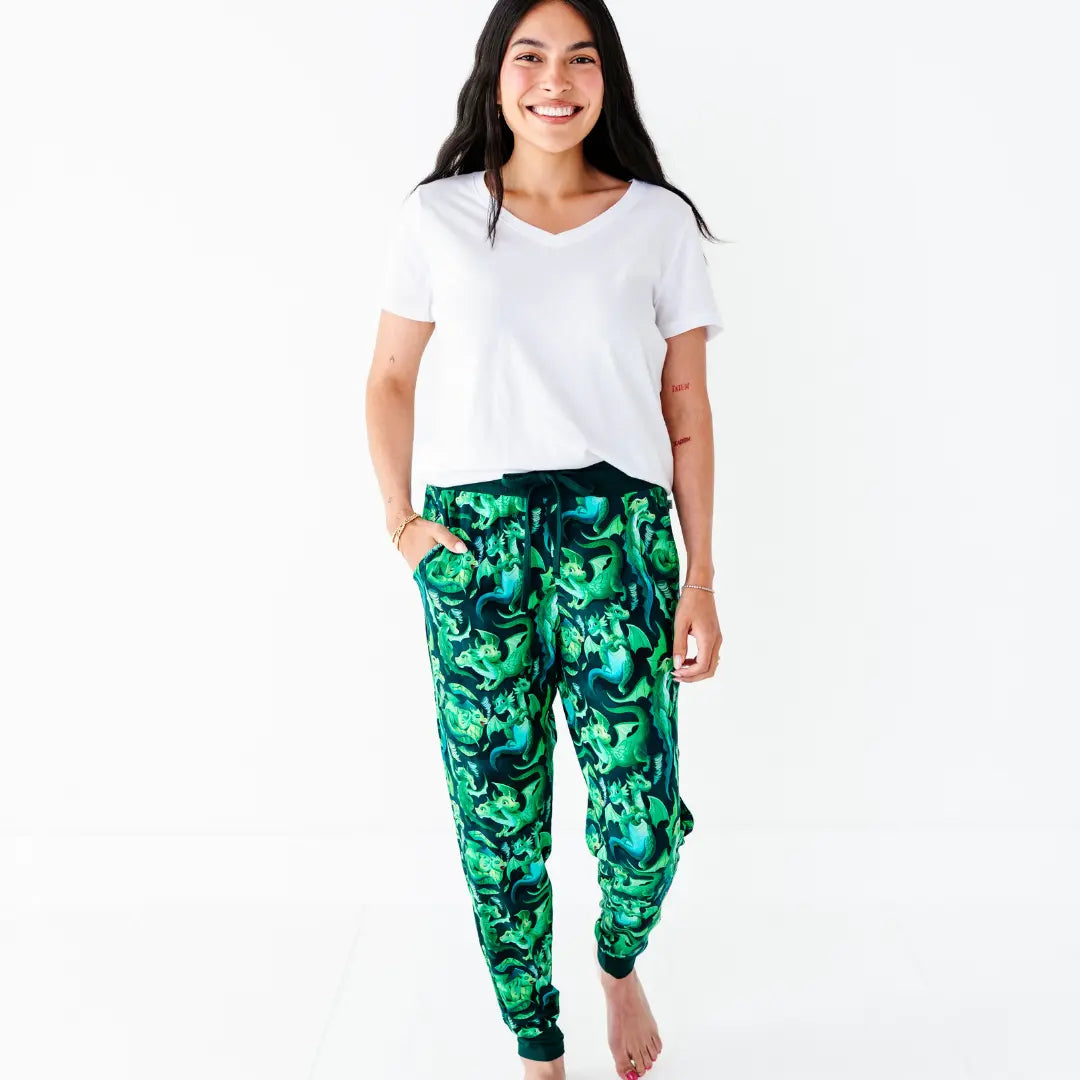 Woman wearing a white t-shirt and green patterned pants on a white background