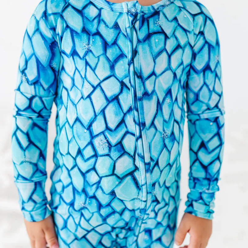 Blue mosaic patterned onesie on a white background