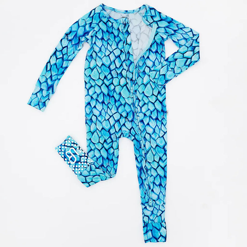 Blue dragon scale patterned onesie with matching headband on a white background