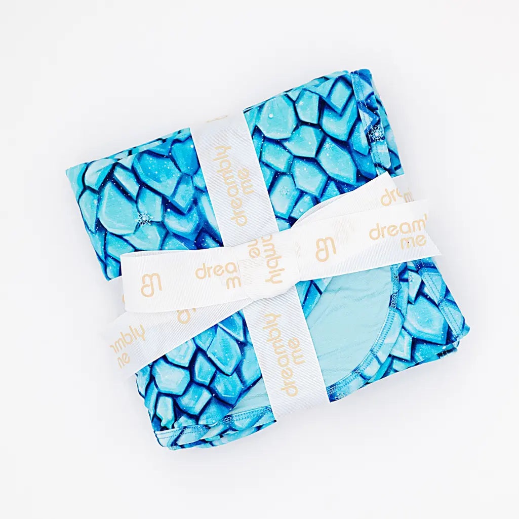 Four blue patterned products with white ribbons on a white background