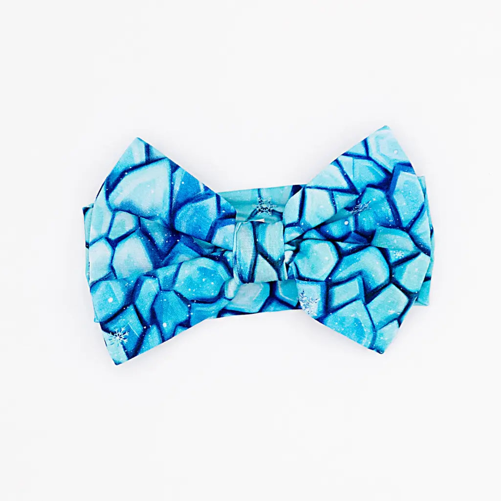 Blue geometric patterned bow tie on a white background