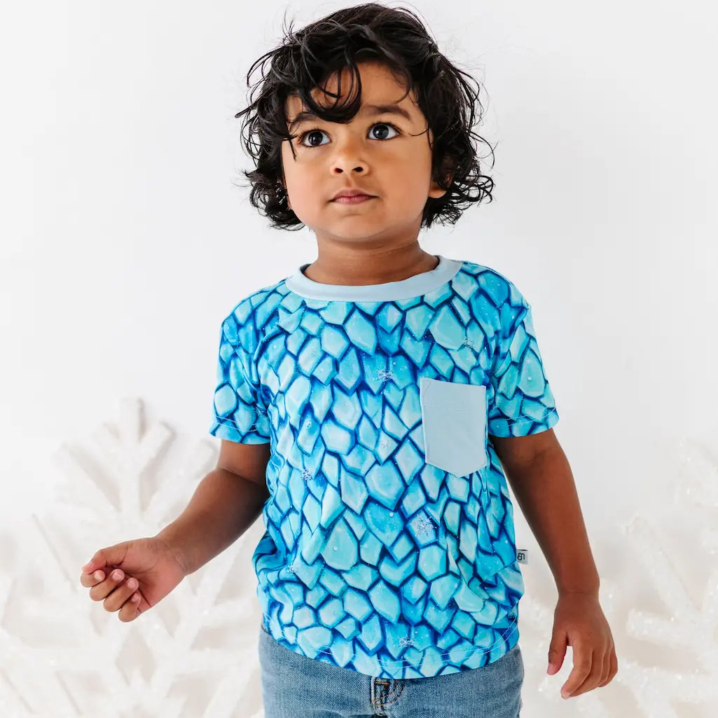Child wearing a blue patterned shirt on a white background