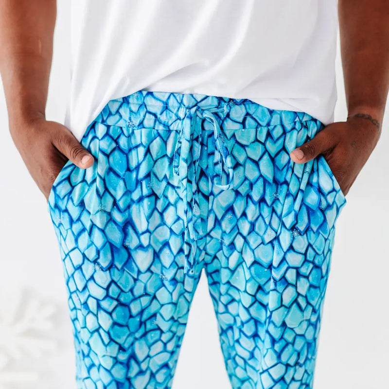 Blue patterned pants worn by a person on a white background