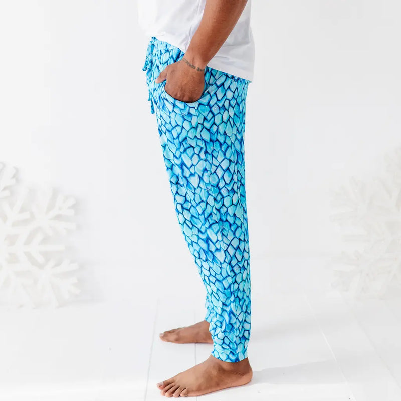 Blue patterned pants worn by a person on a white background