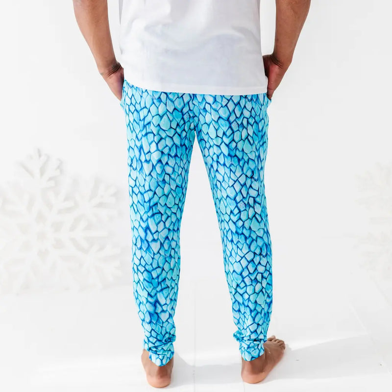 Person wearing blue patterned pants on a white background