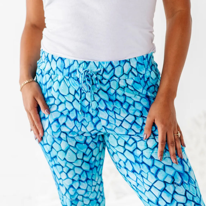 Person wearing blue patterned pants with a white background