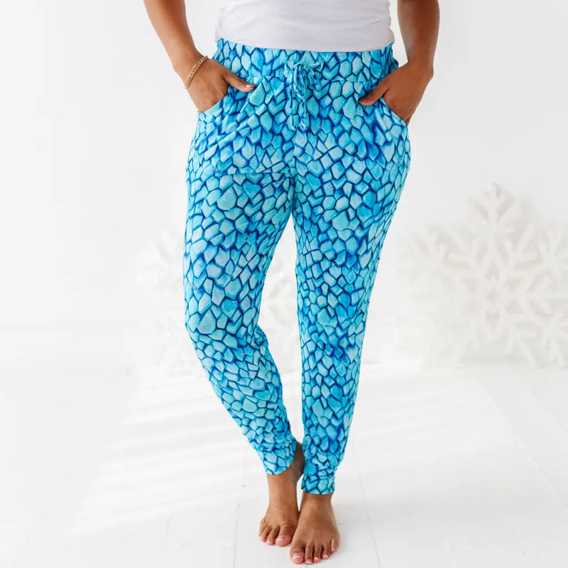 Person wearing blue patterned pants on a white background