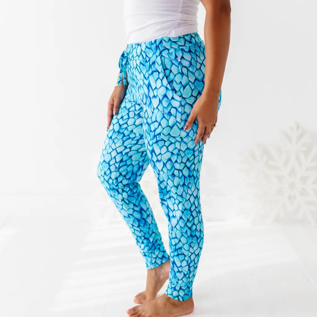 Person wearing blue patterned leggings on a white background