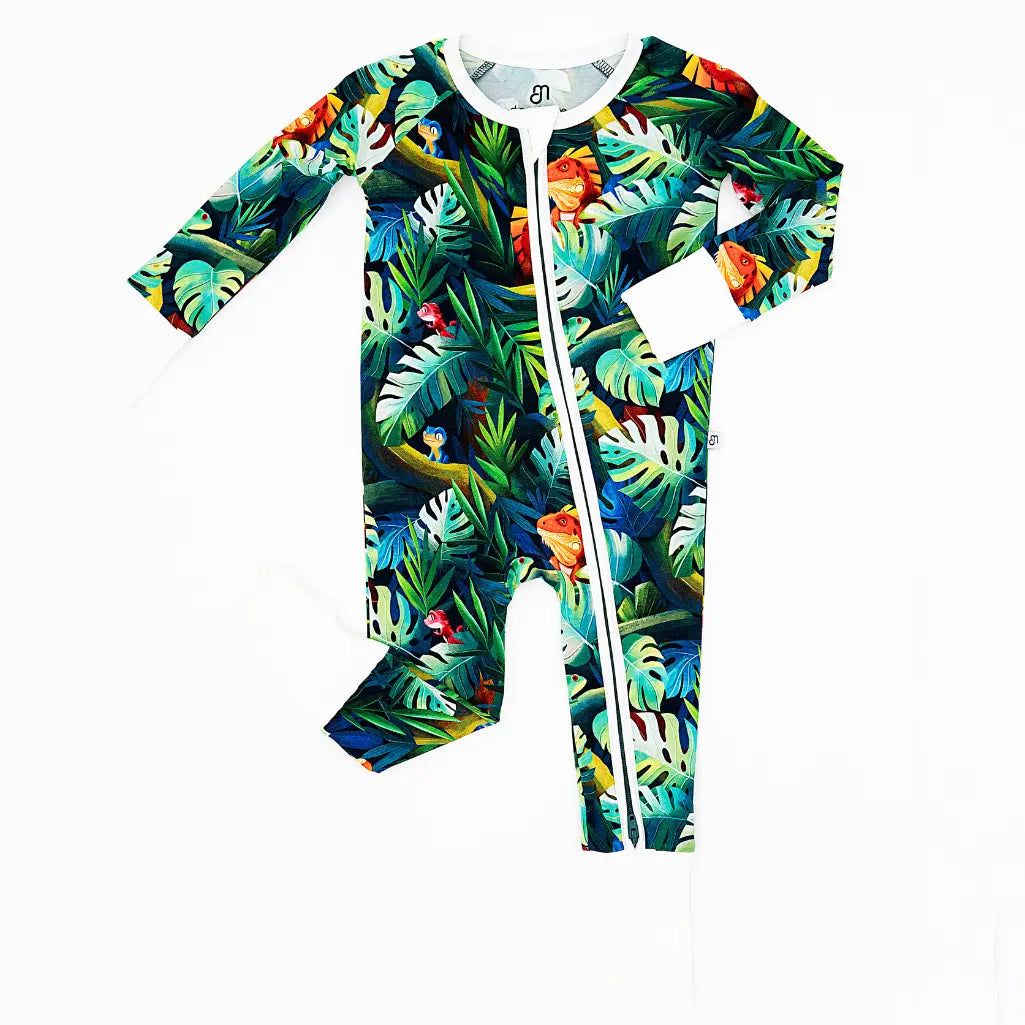 Tropical leaf patterned baby onesie with a zipper on a white background