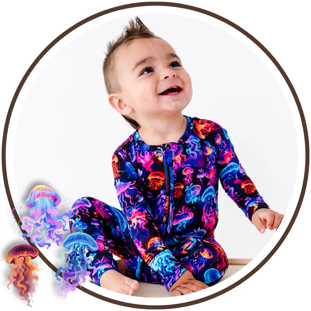 Child wearing a colorful jellyfish patterned outfit with jellyfish illustrations on a white background.