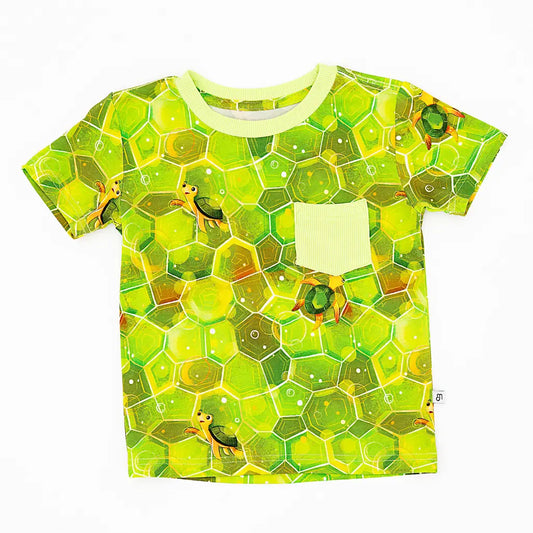 Children's t-shirt with green turtle pattern on a white background