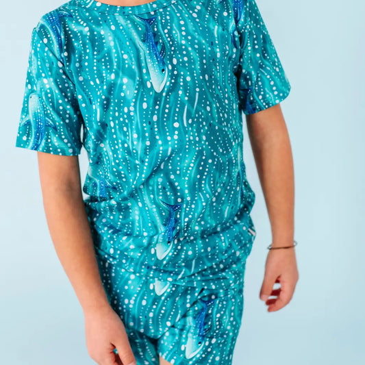 Teal dress with white pattern on a light blue background