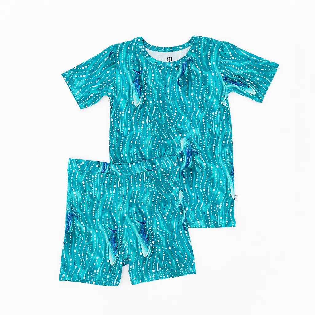 Turquoise children's swimsuit with a pattern on a white background