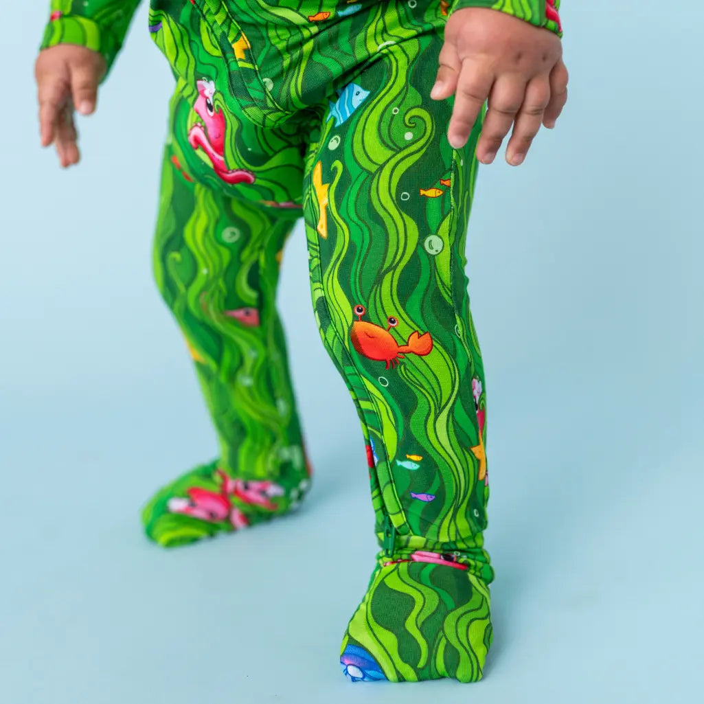 Green children's leggings with underwater-themed design on a light blue background