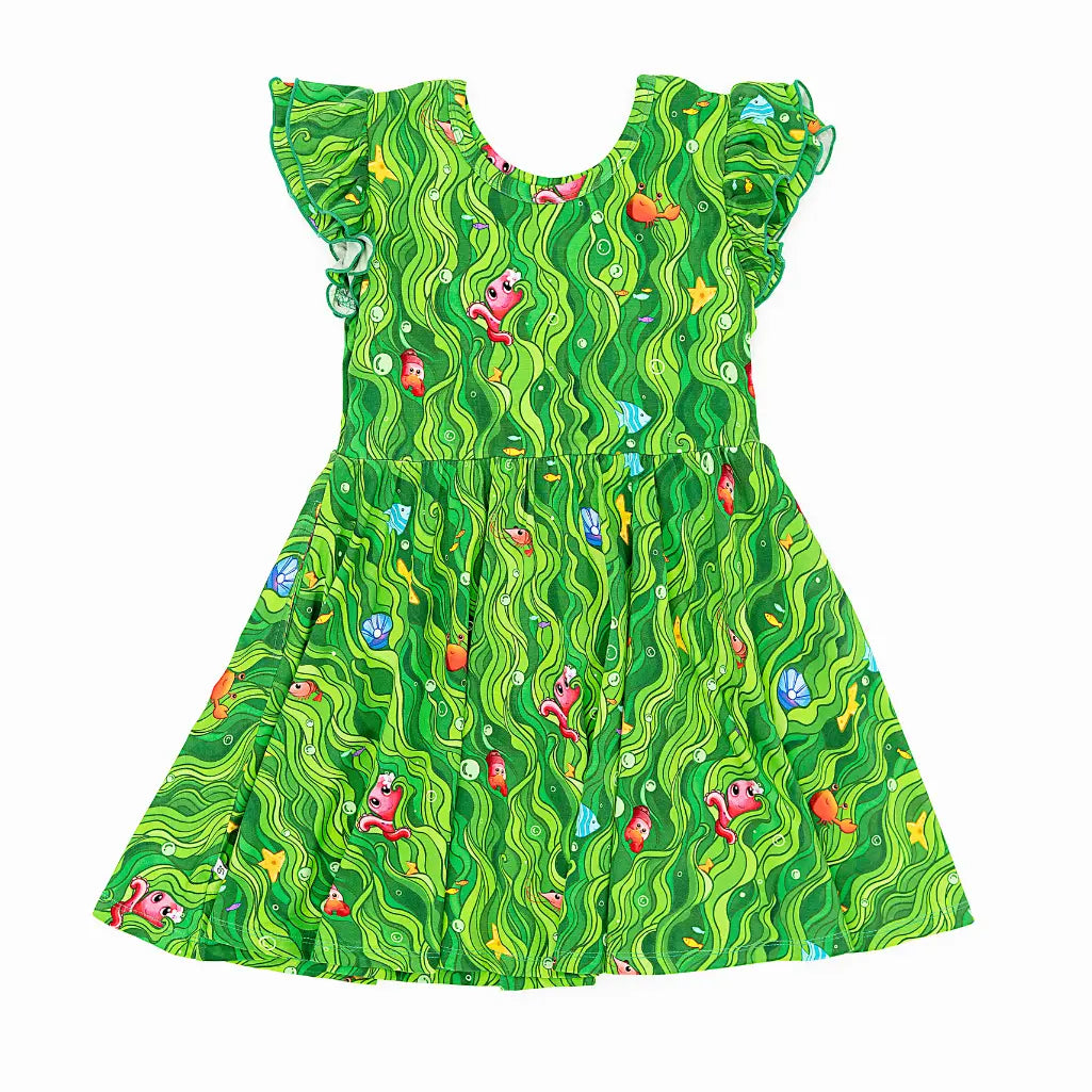 Green dress with colorful fish pattern on a white background