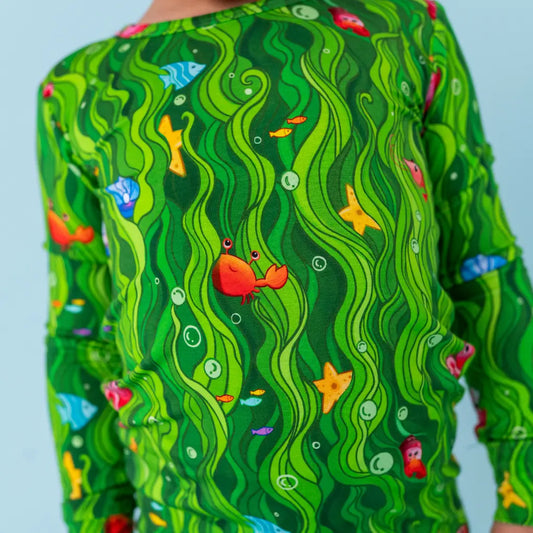 Green patterned shirt with underwater design featuring fish and a crab.
