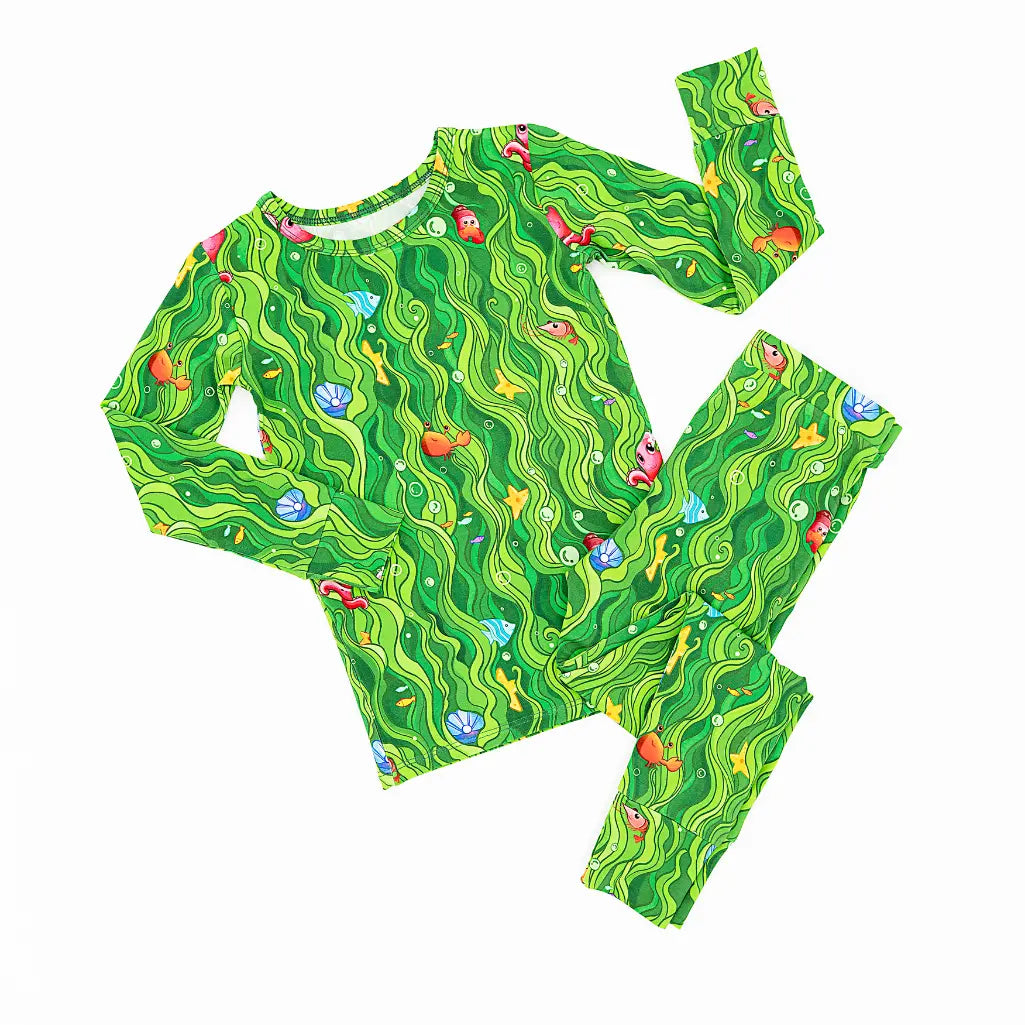 Green children's pajama set with wavy pattern on a white background