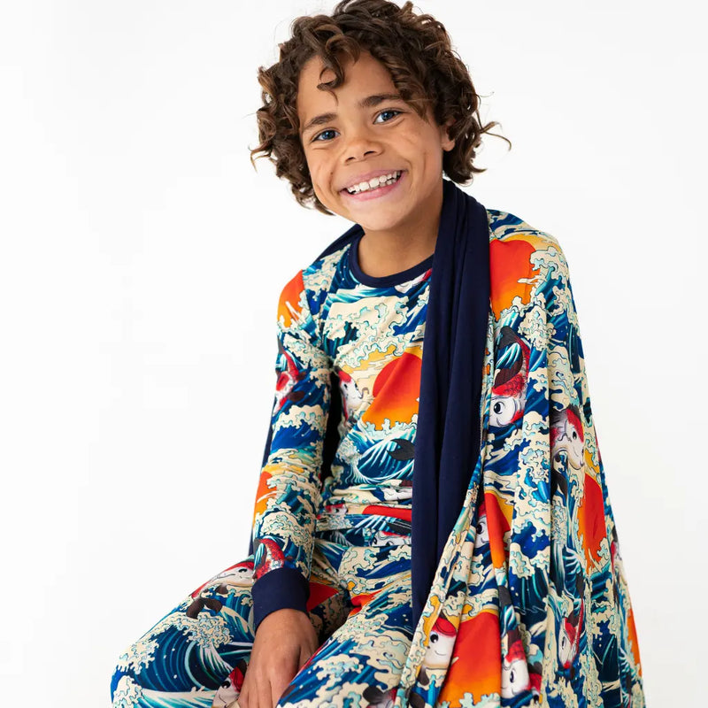 Child wearing a colorful kimono-style outfit with a white background