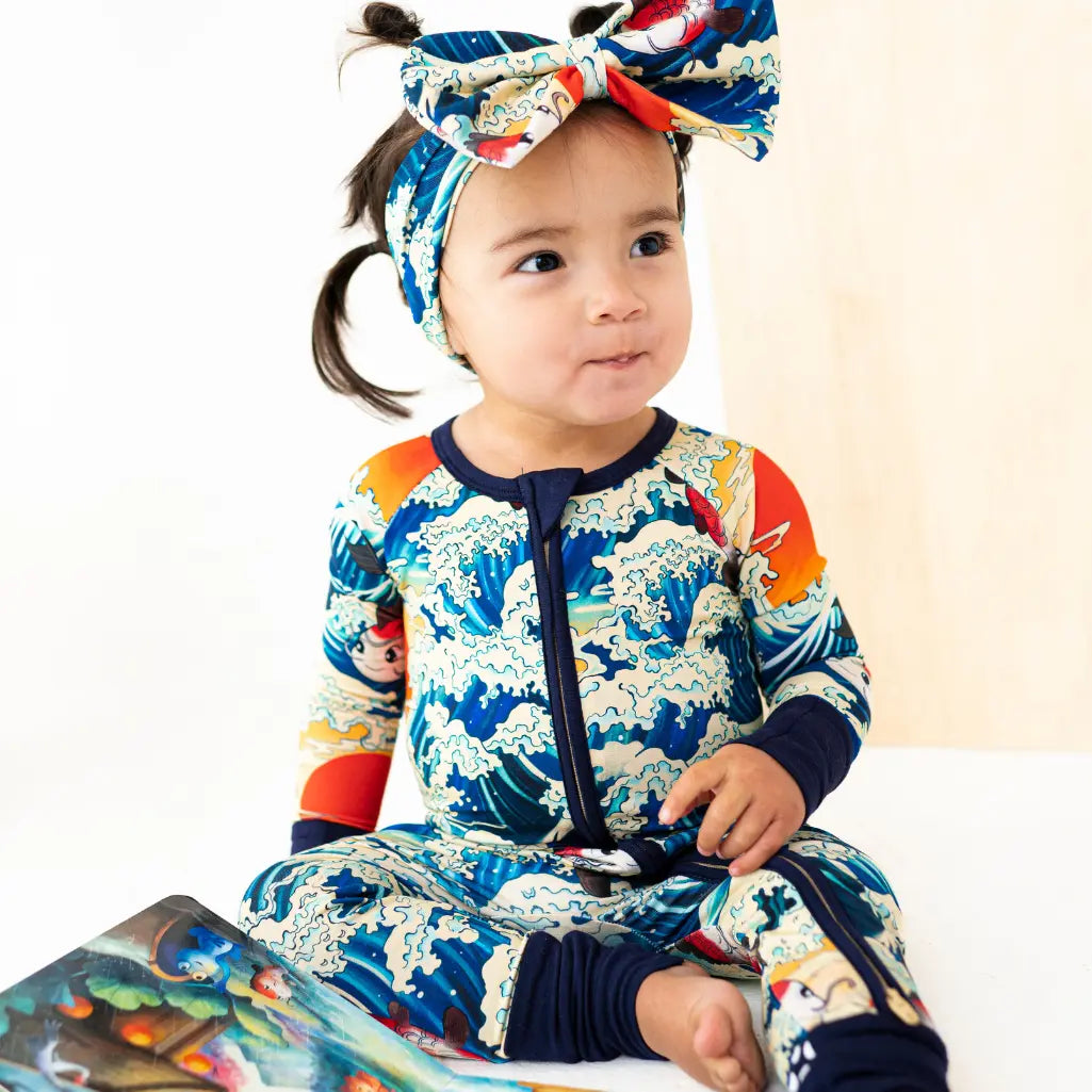 Child wearing a colorful outfit with a headband on a white background