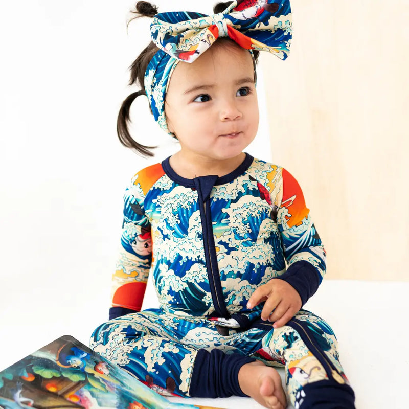 Child wearing a colorful outfit with a headband on a white background