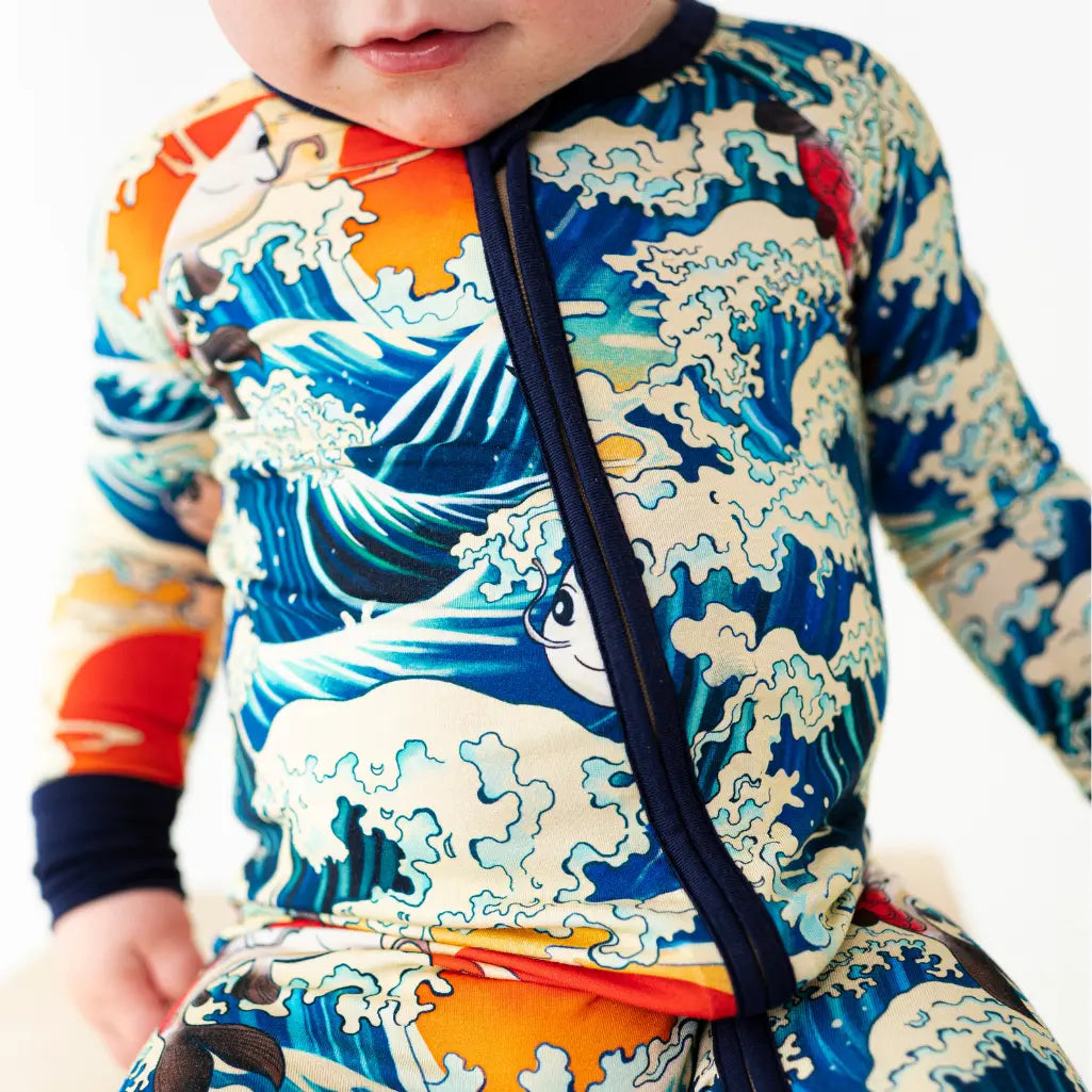 Child wearing a colorful rash guard with wave design