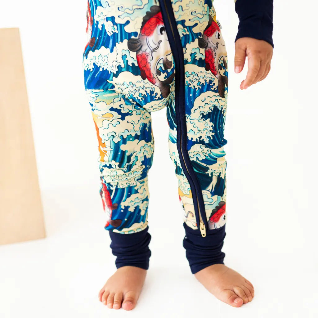 Colorful children's onesie with a dragon design on a white background