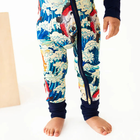 Colorful children's onesie with a dragon design on a white background