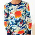 Colorful long-sleeve shirt with fish and wave design on a white background