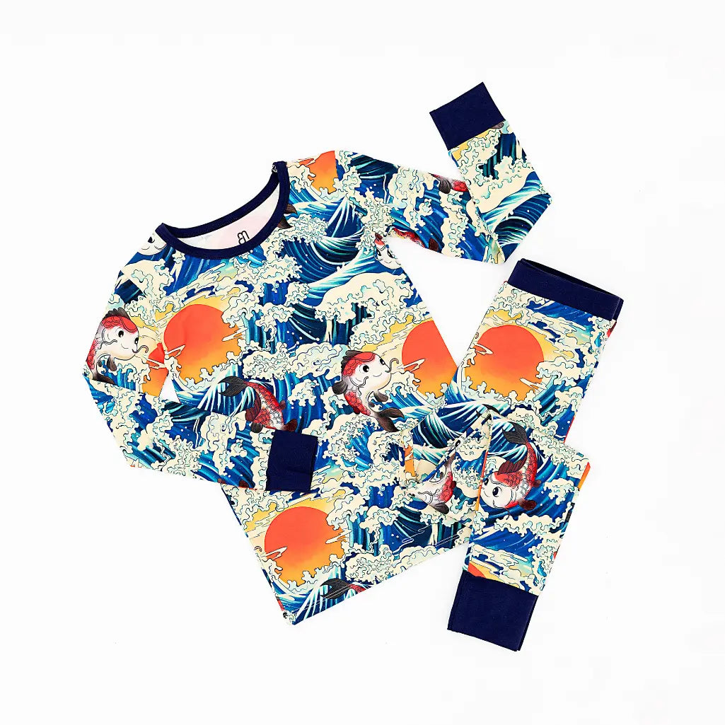 Children's pajama set with ocean wave and parrot pattern on a white background