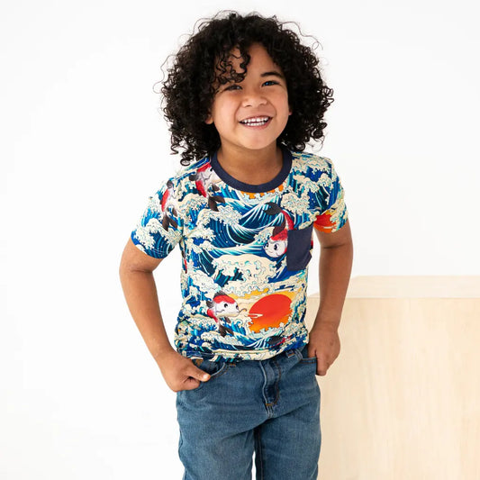 Child wearing a colorful t-shirt with a design on a white background