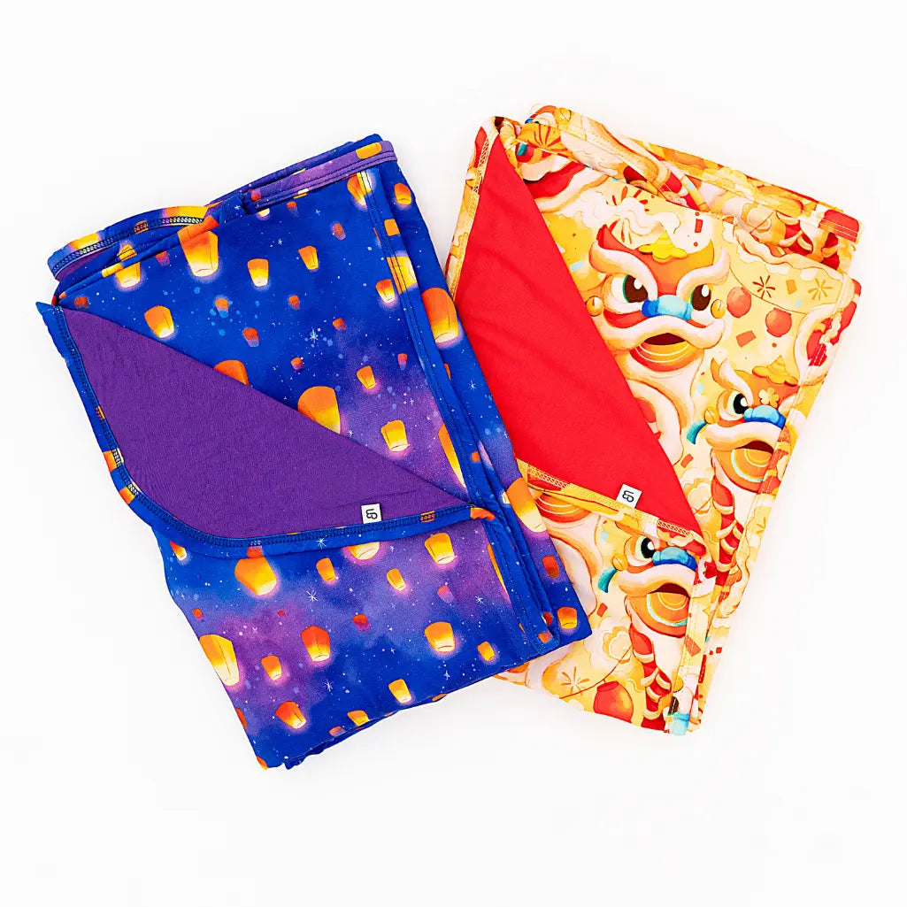 Two colorful fabric swatches, one with a space-themed pattern and the other with cartoon character design, on a white background.
