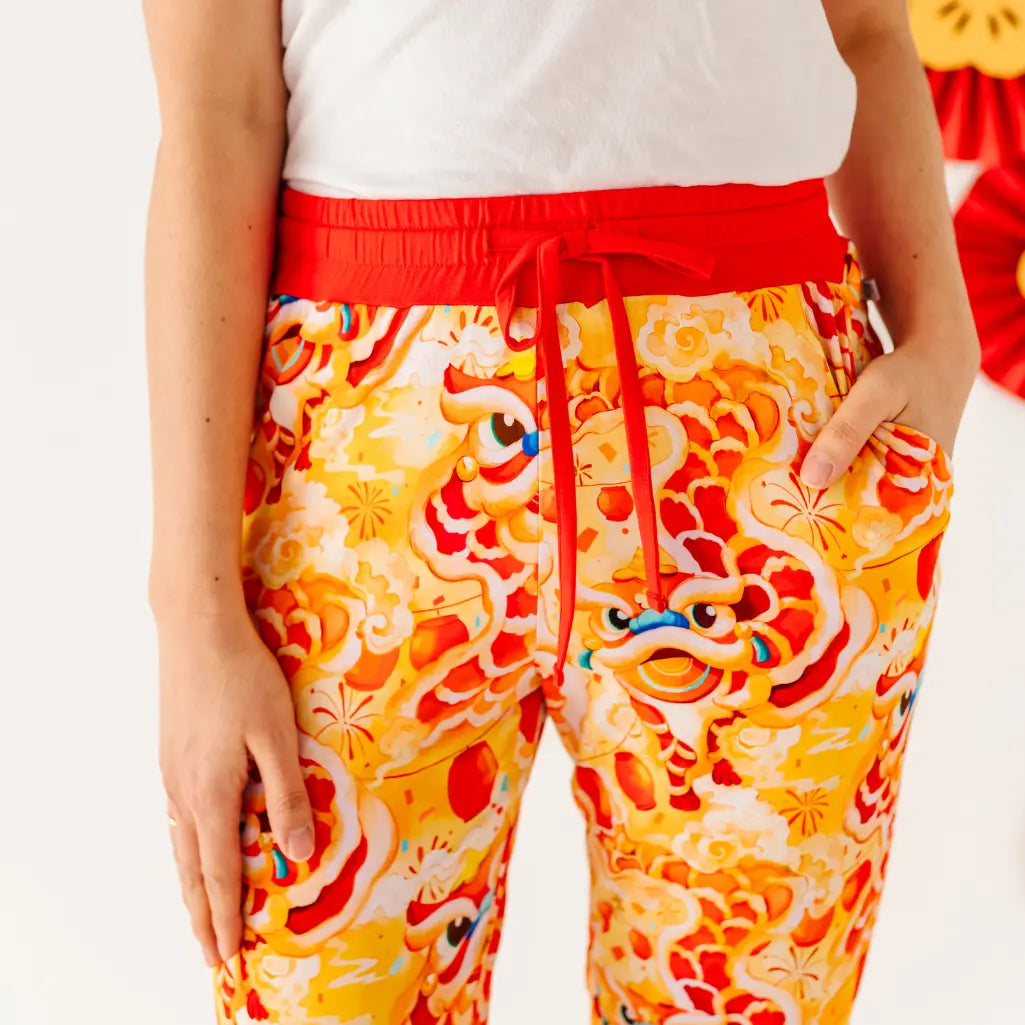 Colorful pants with a dragon design on a plain background