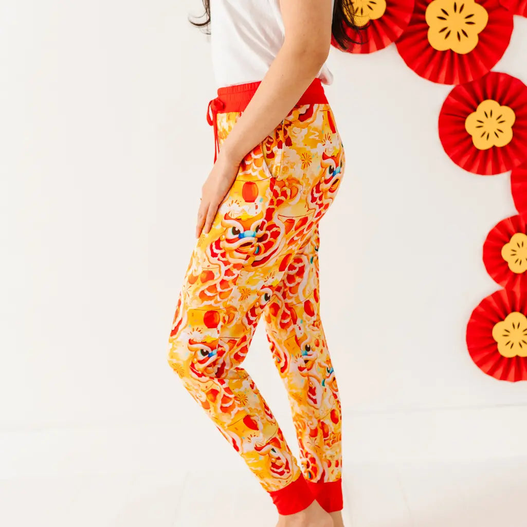 Colorful dragon-themed pants with red and yellow design on a white background